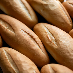 Freshly baked loaves with wheat flour on tray. Buns for breakfast. Fresh bakery. Healthy diet. Bakery. Close-up. Side view. Soft focus. High quality photo