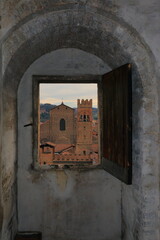 View of the city from a small window in the bell tower of St. Peter's Cathedral in Bologna.
