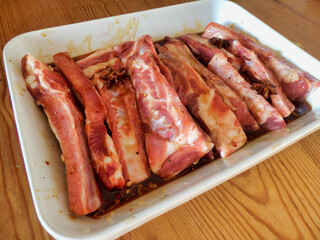 Spare ribs marinating in a home made marinade made of honey, oyster sauce, garlic, chilli flakes, star anise, salt and pepper 
