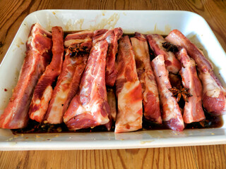 Spare ribs marinating in a home made marinade made of honey, oyster sauce, garlic, chilli flakes, star anise, salt and pepper 
