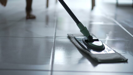 Mop close up cleaning dirty floor at home
