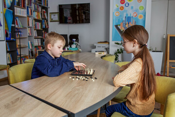 Children play game of chess. Concept of education, hobby and leisure.