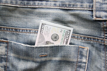 Money in pocket. Dollar bills in a back pocket of jeans.