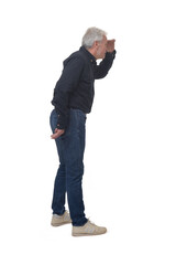 Naklejka premium side view of standing man looking away with hand on forehead on white background