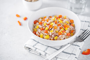 Fototapeta na wymiar Corn red bell pepper black and white and brown rice in a bowl