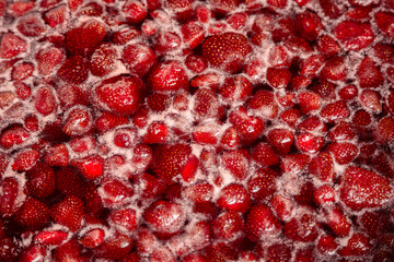 Strawberry jam simmering slightly, detailed close-up, top view. Beautiful strawberry jam in cooking process. Boiling homemade strawberry jam. Making a homemade Strawberry Jam. Boiling fruit into a pan