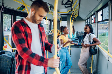 Two african american woman riding together in a bus