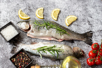 raw trout with spices on stone background