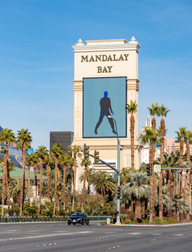 Las Vegas, United States - November 23, 2022: A picture of the Mandalay Bay billboard and the surrounding palm trees.
