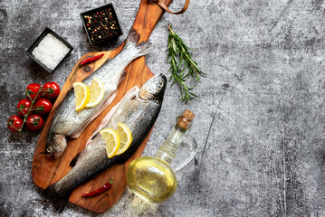 raw trout with spices on stone background with copy space for your text