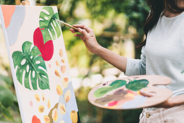 Female artist painting art canvas drawing with inspiration in garden art therapy creativity...