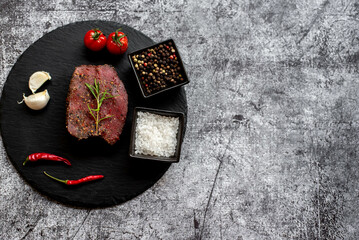 raw beef steak on stone background with copy space for your text