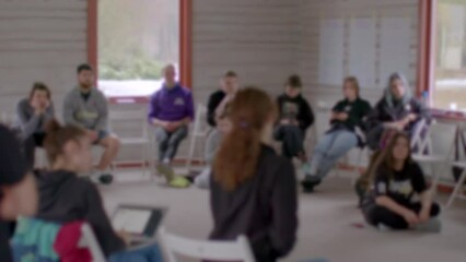 People in bokeh indoor. Twelve-step program are international mutual aid program supporting recovery from substance, behavioral addictions and compulsions. 