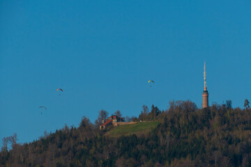 Gleitschirmflieger über dem historischen Merkur Turm Baden-Baden