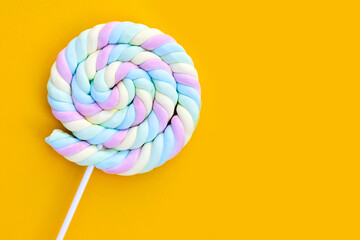 Round and twisted colorful marshmallow lollipop with stick