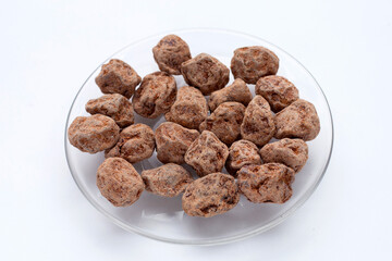 Dried salted Chinese plum isolated on white background