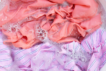 Fototapeta premium Top view of formal shirts soak in powder detergent water dissolution. Laundry concept