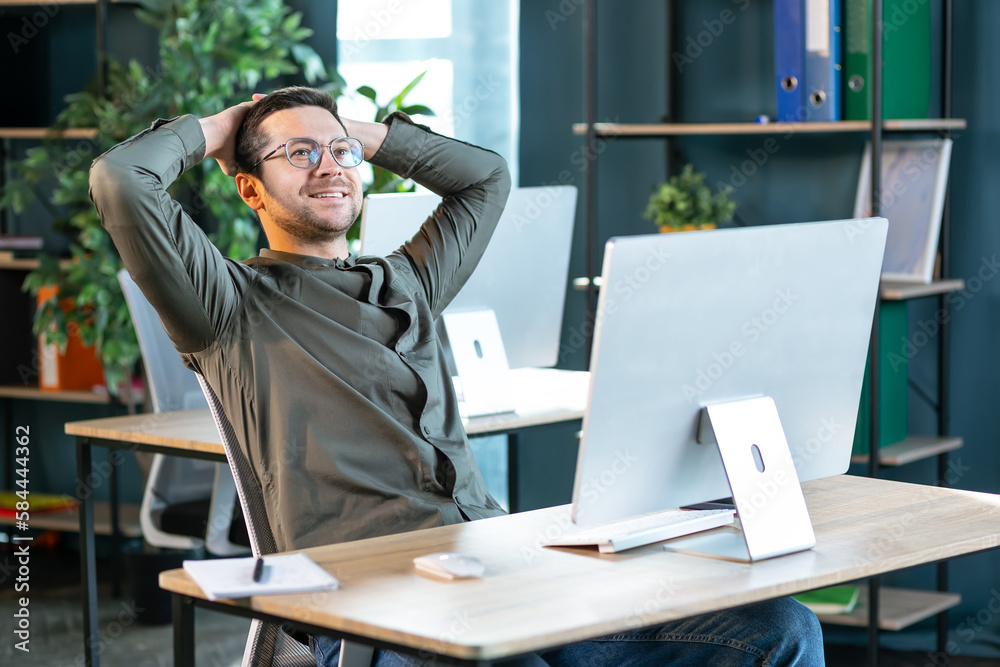 Wall mural taking break from work. relaxed businessman resting on chair, leaning back at workplace, positive ma