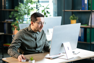 Get unexpected news. Shocked man, office employee, CEO, looking in surprise at the computer screen...