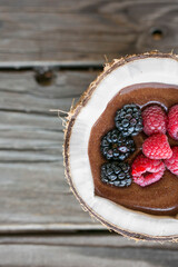 chocolate mousse in a coconut with berries 