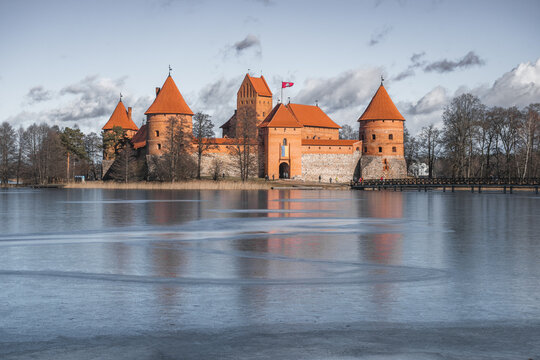 Medieval castle of Trakai, Vilnius, Lithuania, Eastern Europe, located between beautiful lakes and nature with wooden bridge in the early spring and frozen lake