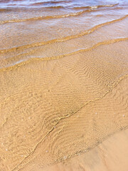Sandy beach and clear sea water. Minimal summer creative concept.