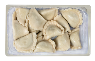 Dumplings in foil packaging ready to be reheated in the kitchen. Food from the market. Isolated background.
