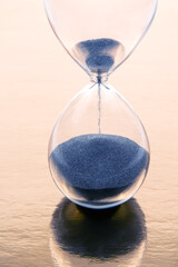 hourglass on a golden background. time and minute measurement