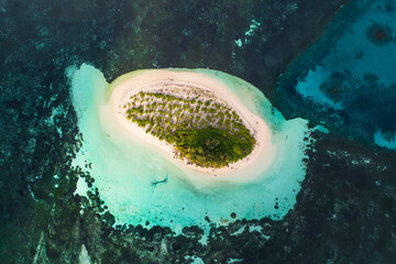 Aerial view of a tiny tropical island in the ocean