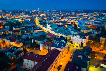 Fototapeta na wymiar Aerial view of illuminated streets and buildings at night, Rzeszow, Poland
