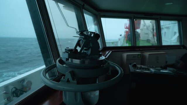 Ship in strom. View from bridge. Pitching. Direction finder in foreground.