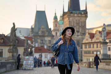 Female traveller tourist on the Charles Bridge in Prague, Czezh Repubic. Stylish beautiful young...