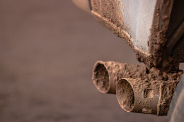 Dirty silver truck exhaust pipes and step bar covered in mud, Off road, Mudding, Bad road conditions, Copy space