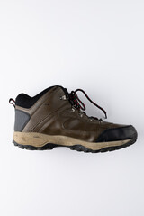 Close up of brown trekking shoe on white background with copy space