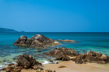 Tropical sea and rocks against blue sky at Phuket province, Thailand.