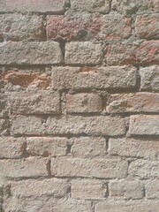 Rustic exposed solid brick wall in external environment of residence wall