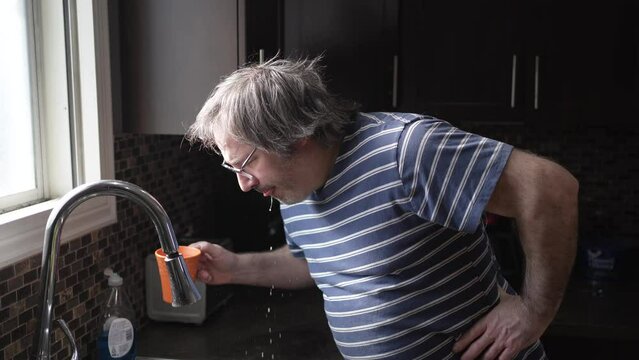 Middle age Man Drinking and Spits Out Bad Taste Coffee