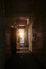 Fototapeta na wymiar Dark and creepy corridor of old abandoned mental hospital