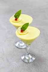 Vegan Lemon cream jelly, Panna Cotta in a martini glass. Light background	