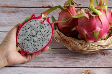 Closeup Dragon Fruit cut into small pieces on old wooden table.