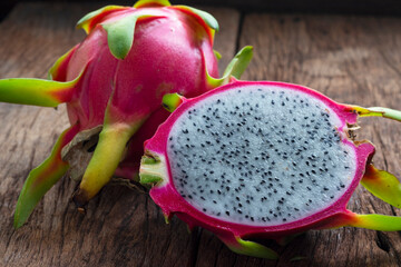 Closeup Dragon Fruit cut into small pieces on old wooden table.