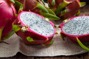 Closeup Dragon Fruit cut into small pieces on old wooden table.