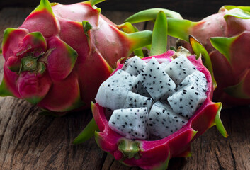 Closeup Dragon Fruit cut into small pieces on old wooden table.
