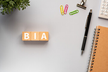 There is wood cube with the word BIA.It is an abbreviation for Business Impact Analysis as eye-catching image.