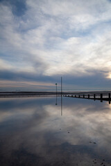 Reflections on Westcliff beach, Essex, England, United Kingdom