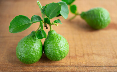 Kaffir lime, Leech lime, Mauritius papeda fruit on wooden table background