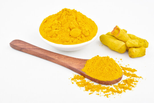 Turmeric powder with raw turmeric isolated on white background