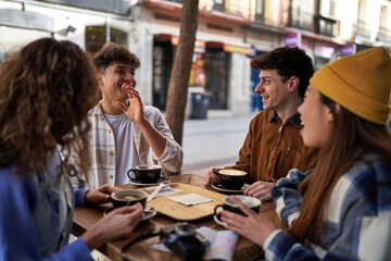 A multicultural group of friends enjoying coffee and tea after their vacation.