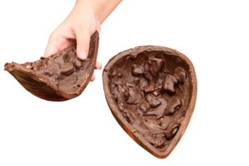 Child picking up half of dark chocolate Easter egg with crunchy almonds.