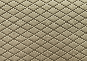 Khaki leather background and texture as a pattern for the interior car or a sofa or wall covering